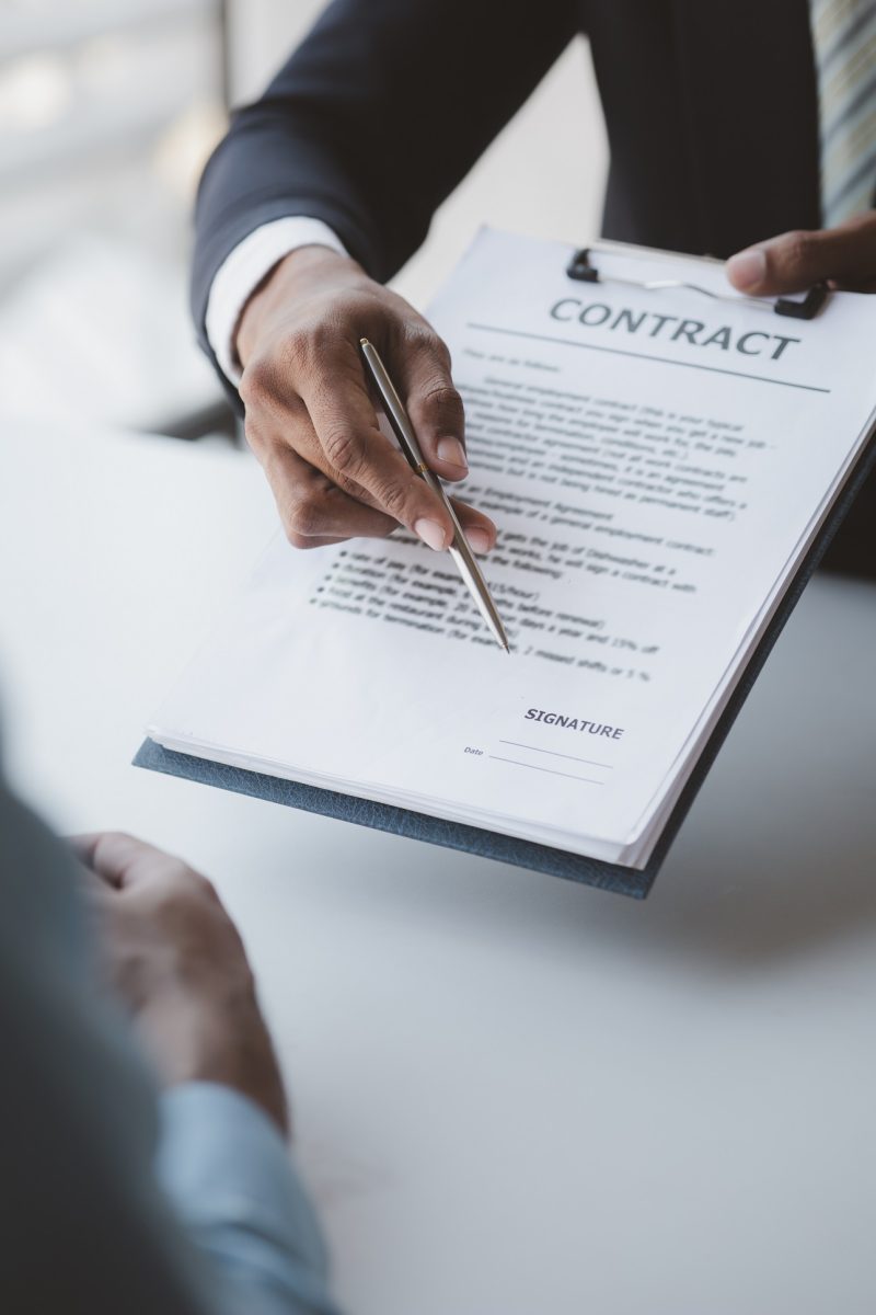 Real estate agents explain models of housing estates in projects to elaborate to clients, explaining and presenting information about homes and purchasing loans. Real estate trading concept.